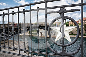 railing on the waterfront of the city of taranto, in the south of italy, in front of the swing bridge photo