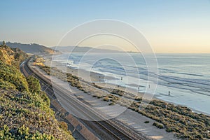 Railroad along cliff overlooking the beach at Del Southern California at sunset