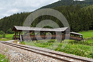 Railroad along the river Mur and an ancient wooden bridge, Austria, alpine landscape