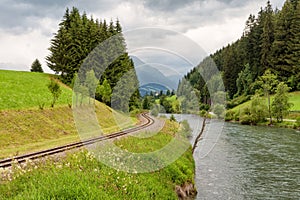 Railroad along the river Mur, Austria, alpine landscape