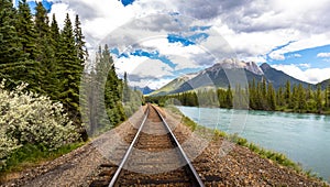 Railroad along the river next to a mountain