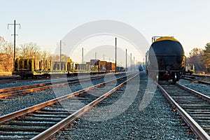 Railroad in autumn going to the city with colorful trees in colors by the tracks in the fall