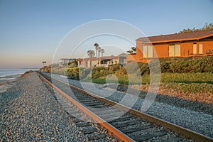 Railroad and beach houses on a cliff at Del Mar Southern California at sunset