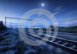 Railroad and blue sky with moon and clouds at night