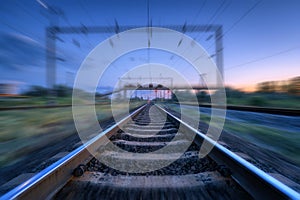 Railroad and blue sunset sky with clouds with motion blur effect