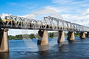 Railroad bridge in Kyiv across the Dnieper with freight train