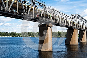 Railroad bridge in Kyiv across the Dnieper with freight train