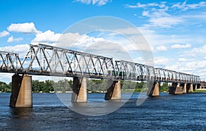 Railroad bridge in Kyiv across the Dnieper with freight train
