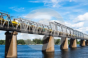 Railroad bridge in Kyiv across the Dnieper with freight train