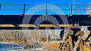Railroad Bridge over frozen river stream in winter