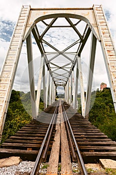 Railroad bridge railway. Connecting two banks of the river in the Amazon forest. vertical layout