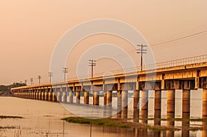 Railroad bridge on sunset background.