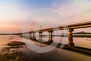 Railroad bridge on sunset background.