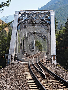 A railroad bridge and tracks are seen end-on in the Feather River Canyon at Tobin, California. photo