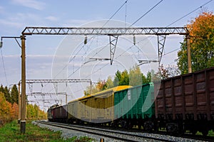 Railroad cars loaded with coal. Freight train. Colored wagons on the railway