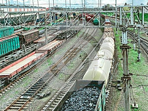 Railroad in the city. metal rails. on the road are freight, red freight wagons, large and capacious wagons transport black bulk
