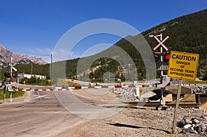 Railroad crossing arms and caution sign