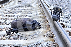 Railroad crossing. on it is a backpack, shoes, glasses. The concept of increased attention to the ways