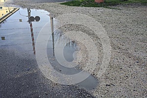 Railroad crossing casted in a puddle