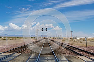 Railroad crossing gates on a road in the Mojave Desert