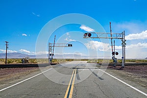 Railroad crossing gates on a road in the Mojave Desert