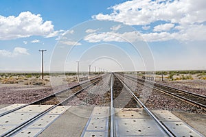 Railroad crossing gates on a road in the Mojave Desert