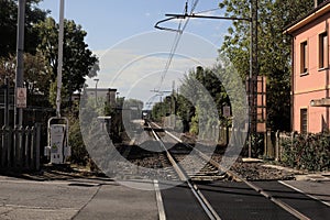 Railroad crossing with a house in the countryside on a clear day