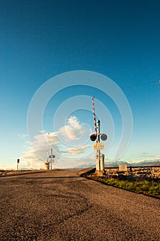 Railroad crossing with mountains behind