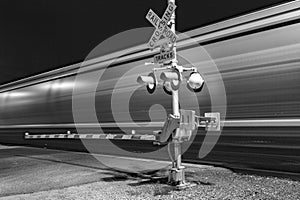 Railroad crossing by night with sign