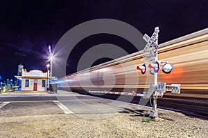 Railroad crossing by night with sign