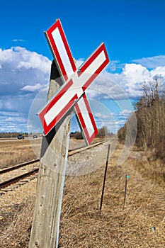 Railroad crossing sign along gravel road