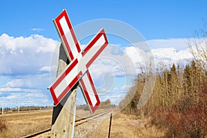 Railroad crossing sign along gravel road