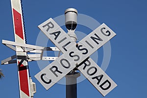 Railroad crossing sign on blue sky background