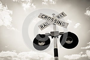 Railroad Crossing Sign with clear sky and white clouds. Railway crossing sign with flashing lights
