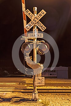 Railroad crossing sign by night