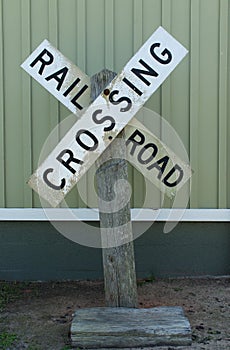 Railroad crossing sign on old wood post