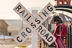 A Railroad Crossing sign with playground background