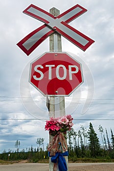 Railroad crossing stop sign with flowers