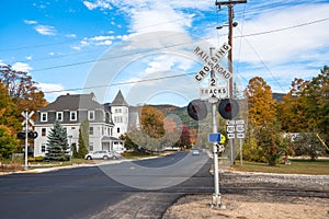 Railroad crosssing with signals in a mountain town on a clear autumn day