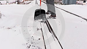 Railroad employee clean snow from the railway crossing