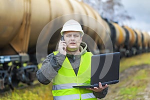 Railroad employee with phone and PC