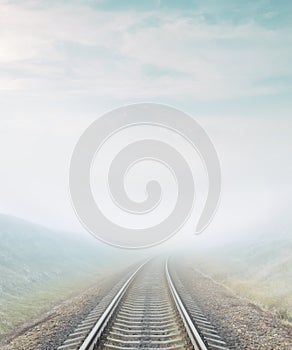 Railroad go to horizon in fog