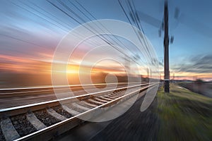 Railroad in motion at sunset. Railway station