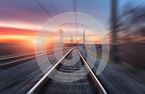 Railroad in motion at sunset. Railway station