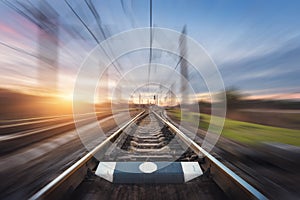 Railroad in motion at sunset. Railway station