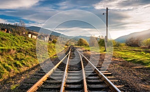 Railroad in mountains at sunset in autumn