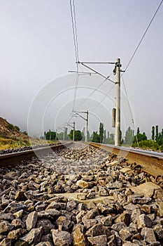 Railroad in the nature on a foggy morning