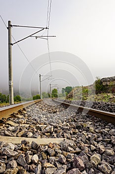 Railroad in the nature on a foggy morning