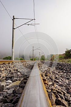 Railroad in the nature on a foggy morning