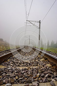 Railroad in the nature on a foggy morning